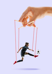 Woman like a puppet in somebodies hands on purple background. Concept of unfair manipulation,...