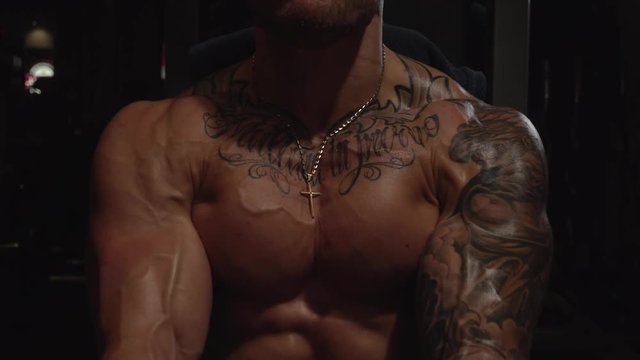 Pec fly machine exercise of fit guy in gym, slow motion, 250fps
