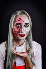 gray haired witch with green eyes on a black background for Halloween