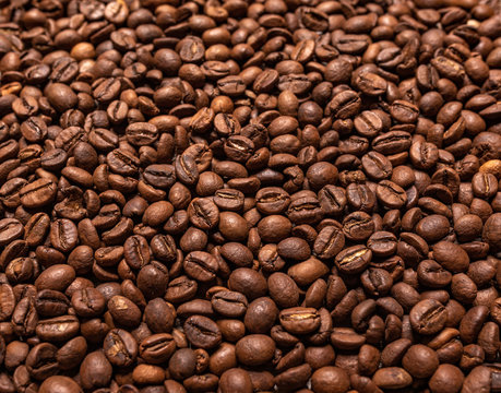 Black coffee beans closeup as a background.
