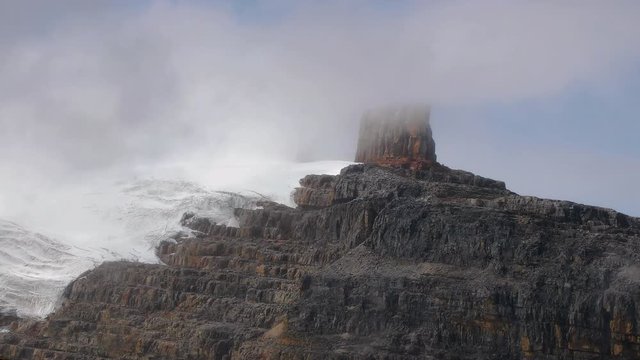 High mountain landscape with rough snowy cliffs, clouds passing by real time in the Andes, Sierra Nevada del Cocuy, Pulpito del Diablo, the Devil's Pulpit