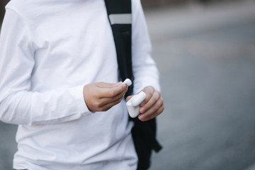 Close up of boy take out a wireless headphones