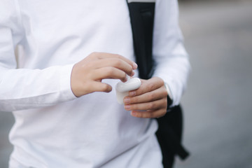 Obraz premium Close up of boy take out a wireless headphones