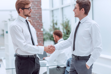 close up. business colleagues shaking hands in the office.