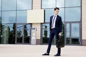 Young businessman in blue suit and tie in and around the conference hall in Sochi