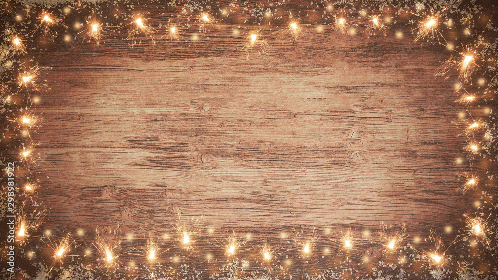 Wall mural frame of lights bokeh flares and sparkler isolated on rustic brown wooden wood table texture - holiday New Year's Eve Sylvester new year 2024 background banner  