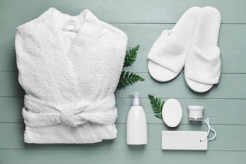 Tuinposter Clean bathrobe with spa supplies on wooden background © Pixel-Shot