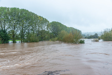 UK flooding warning. River Wye in the village Glasbury-on-Wye.