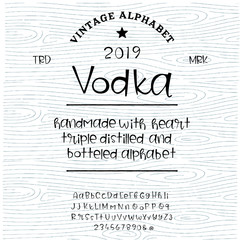 Vintage decorative font  "vodka" with sample design. Good handcrafted western typeface in vintage style for labels, posters, greeting cards etc. Letters and numbers. Vector illustration