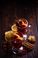 Christmas holidays atmosphere, cold winter day. Warming mood. Mulled wine with cranberry, cinnamon, orange and anise.