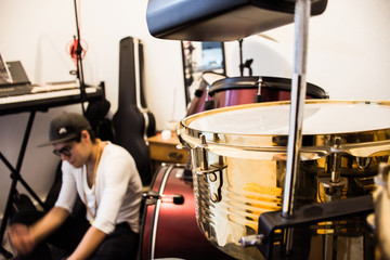 musical instruments and person in a recording studio