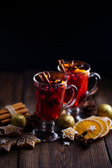 Christmas holidays atmosphere, cold winter day. Warming mood. Mulled wine with cranberry, cinnamon,...
