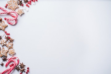 Christmas composition, winter holiday greeting card. Mockup with festive decorations and sweets on white background. Copy space.