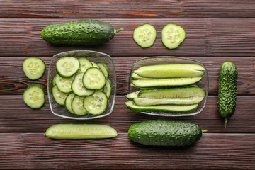 Fresh green cucumbers on wooden background