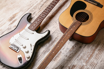 Fototapeta na wymiar Modern guitars on wooden background