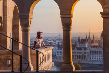 A happy young woman enjoying her trip to the Castle of Budapest in Hungary on the view point from...