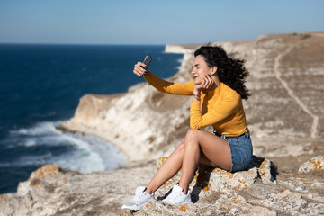 A young girl is photographed against a beautiful landscape.