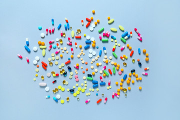 Many different pills on grey background