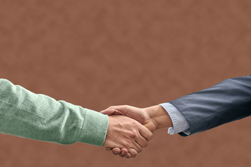 handshake on brown background. verbal agreement concept