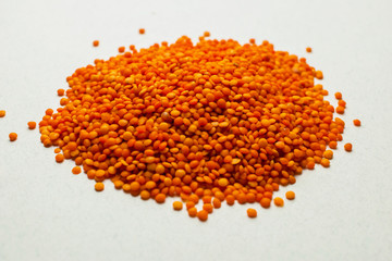 Raw red lentil on a white background with clipping path. Macro Selective focus For vegetarianism...
