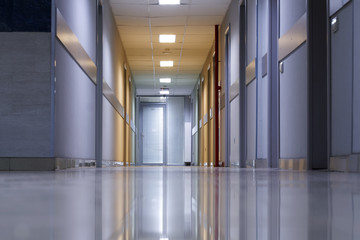 Corridor: floor, ceiling and walls of an office building. Work and business. Interior. An example of installed sockets, switches and smoke detectors