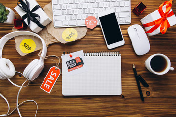 Black Friday board on a white wooden table, top view