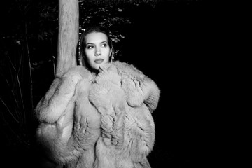 femal model outin nature with fur coat