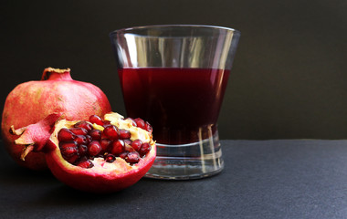 Glass of pomegranate juice and pomegranate fruit