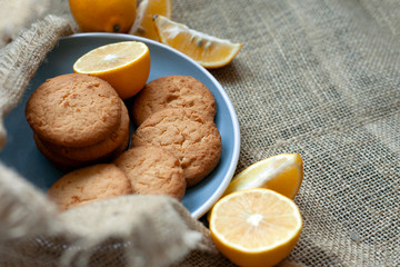 lemon cookies made at home, citrus baking deliciously lies on a plate in the fabric, view from the top