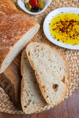 Slice traditional artisan Italian Bread with olive oil dip
