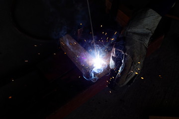 Welder workshop training a welding metal with protective mask and uniform in factory