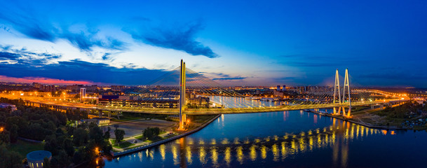 A panoramic view of night St. Petersburg. Bridges Of St. Petersburg. Rivers Of St. Petersburg. Obukhov bridge across the Neva. The lights of the cable-Stayed bridge are reflected in the Neva.