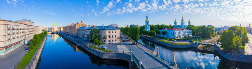 Naklejka premium Panorama of St. Petersburg on a summer day. View of the city from a height. Russia. Rivers Of Petersburg. Kryukov canal and Griboyedov canal. Architecture Of St. Petersburg. Nikolsky Cathedral.
