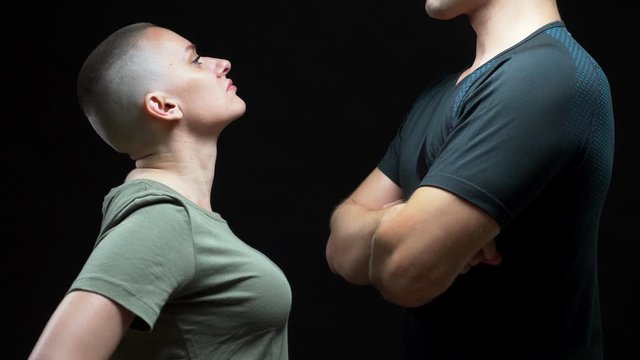 bald woman beats an unrecognizable man. concept of confrontation of sexes, humor