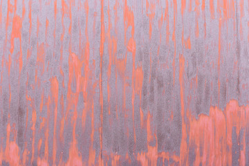 Red color on rusty steel wall for texture background wallpaper