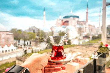 Travel woman with Turkish Tea Looking View of Hagia Sophia in Istanbul, Turkey