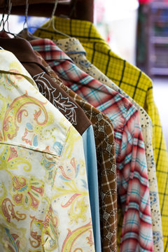 Vintage western style long sleeved shirts with patterns and colors hanging in an antique store in Thorpe, Washington.