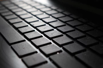 Fotobehang Photo macro digital keyboard computer for business on the dark and little light © niki