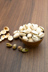 Pistachio nuts on an old wooden background.
