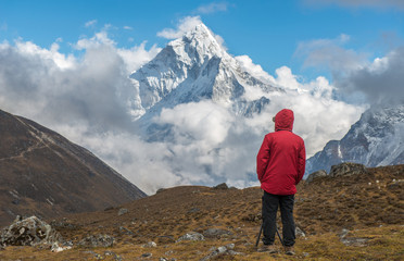 Trekker standing and looking to Mt.Ama Dablam (6,812 m) one of the most beautiful mountain in the World, situated in the Himalaya range of eastern Nepal.