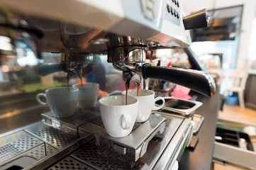 Coffee in white cup on a coffee machine