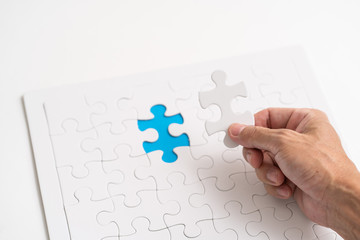 Hand holding jigsaw piece. for business concept