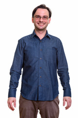 Studio shot of formal young happy man smiling while wearing eyeg