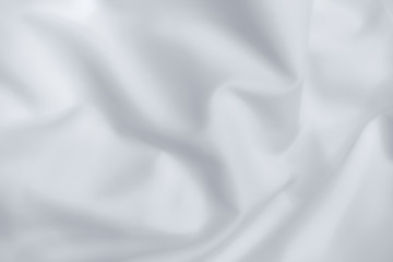 Obraz premium Abstract white fabric texture background. Cloth soft wave. Creases of satin, silk, and cotton.