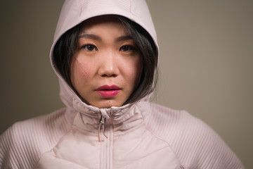 beauty and fashion style isolated portrait of young beautiful and cool Asian Korean student woman in pink hood winter jacket in cute face expression isolated © TheVisualsYouNeed