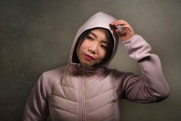beauty and fashion style isolated portrait of young beautiful and cool Asian Korean student woman in pink hood winter jacket smiling happy and cheerful isolated © TheVisualsYouNeed