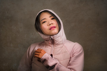 beauty and fashion style isolated portrait of young beautiful and cool Asian Korean student woman in pink hood winter jacket smiling happy and cheerful isolated © TheVisualsYouNeed