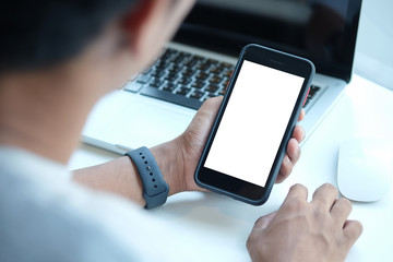 Cropped shot view of man hands holding smart phone with blank copy space screen for your text message or information content, female reading text message on cell telephone during in urban setting. 