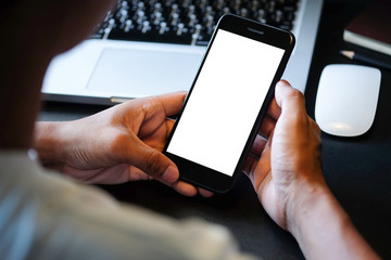 Cropped shot view of man hands holding smart phone with blank copy space screen for your text message or information content, female reading text message on cell telephone during in urban setting. 