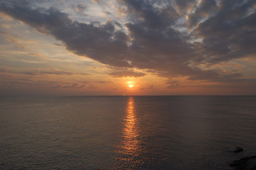 The bright sun rising over Ao Tanot (Tanote Bay) in Koh Tao, Thailand